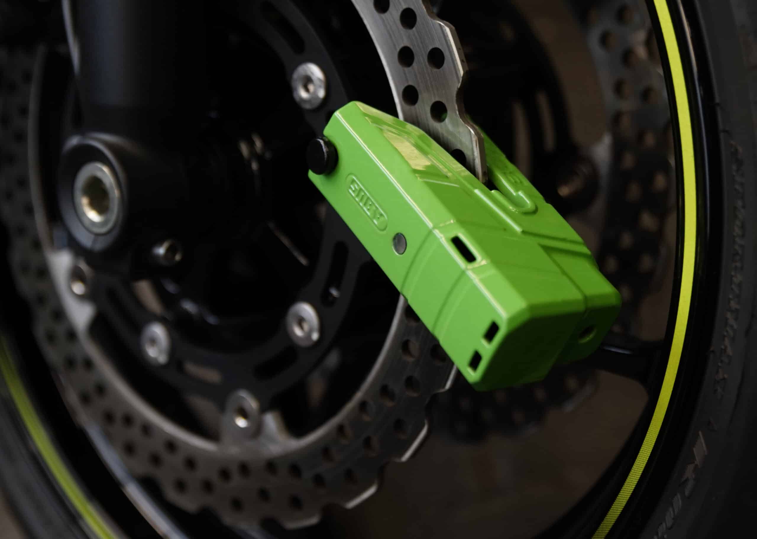 Abus motorcycle brake disc lock in green with alarm